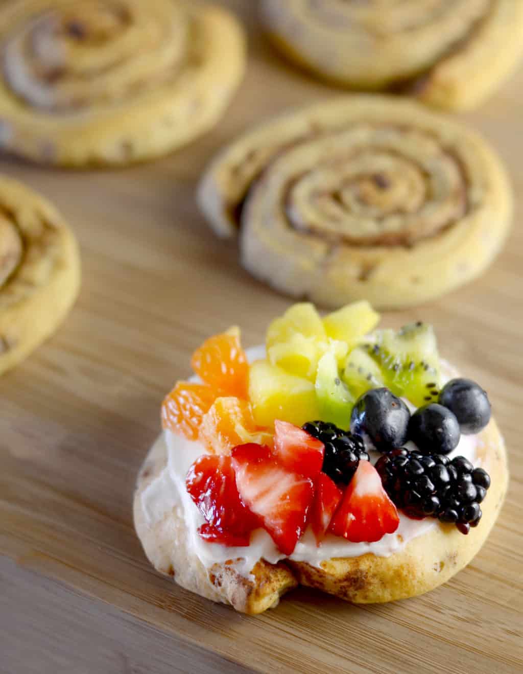 Cinnamon Roll Rainbow Fruit Pizzas! These taste even more amazing than